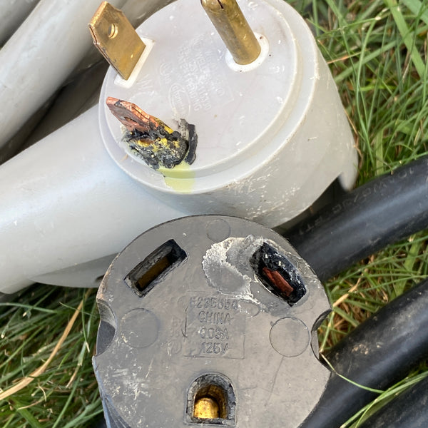 close-up damaged heating pad cord with melted insulation and stiff kinks near plug
